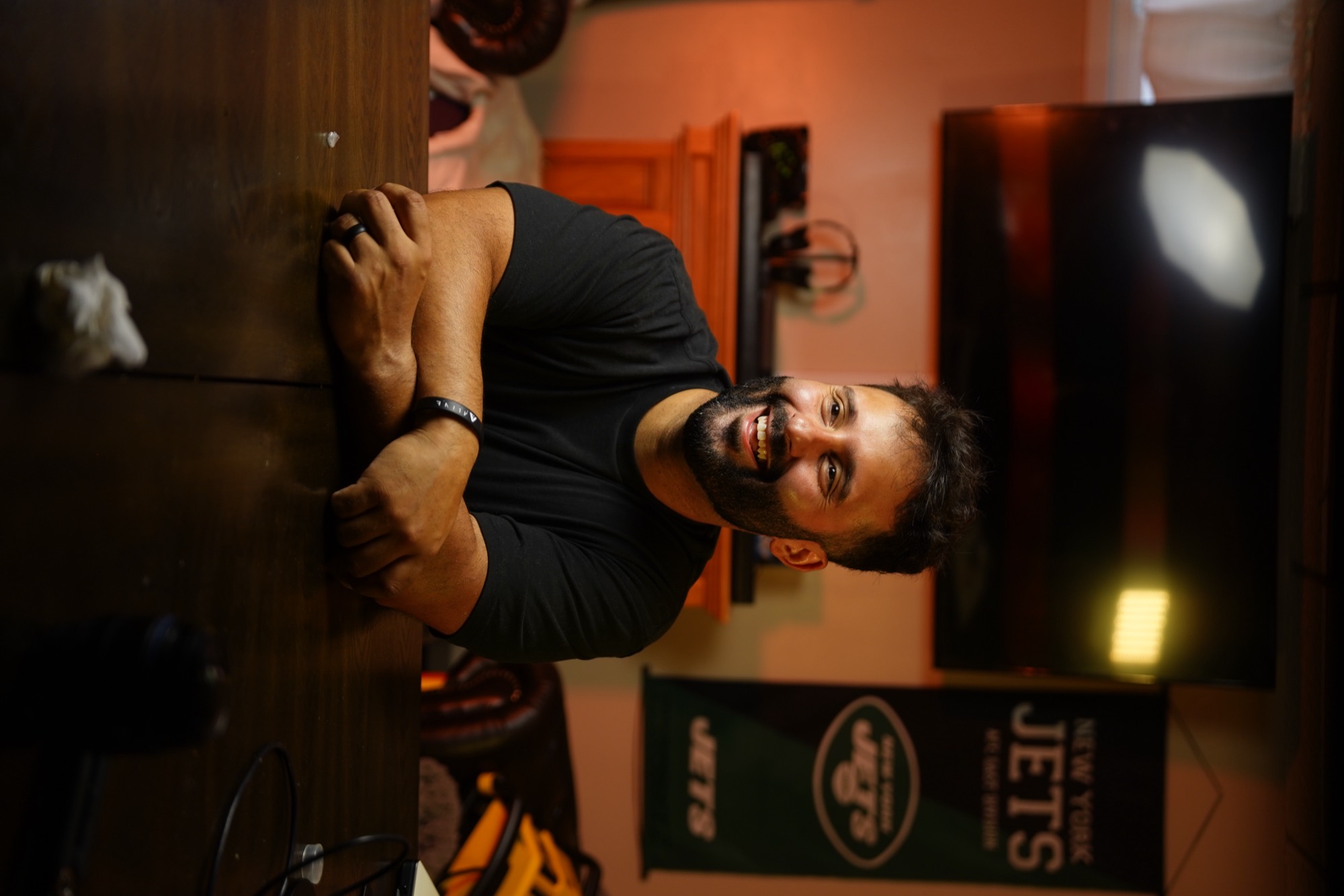 Jon Divine smiling at a table